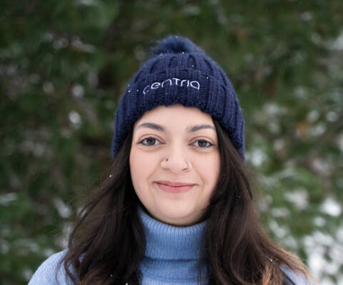 Female student wearing the Centria beanie with tassel.