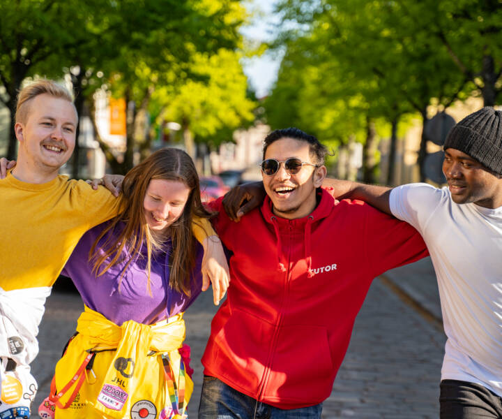 Four students walking and laughing together in Kokkola centre
