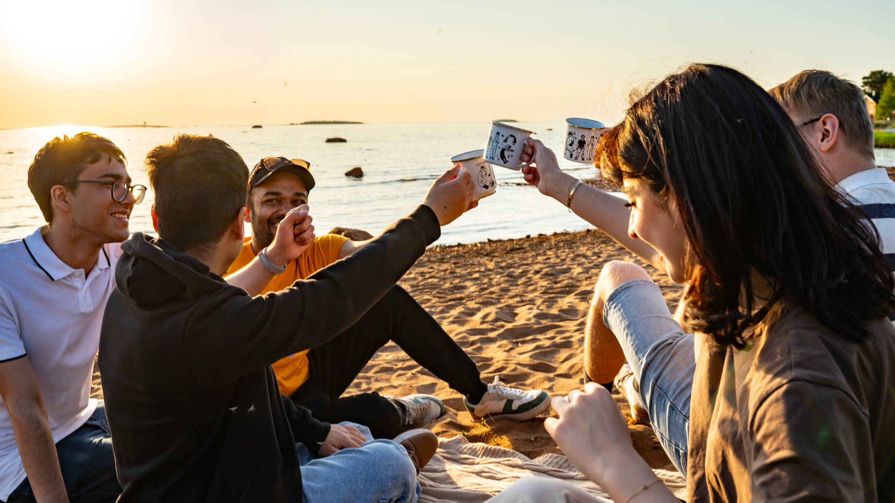 Students on a beach during a sunset in Kokkola